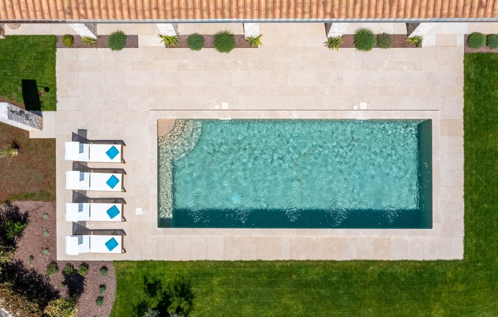 Private villa pool and sun loungers viewed from above