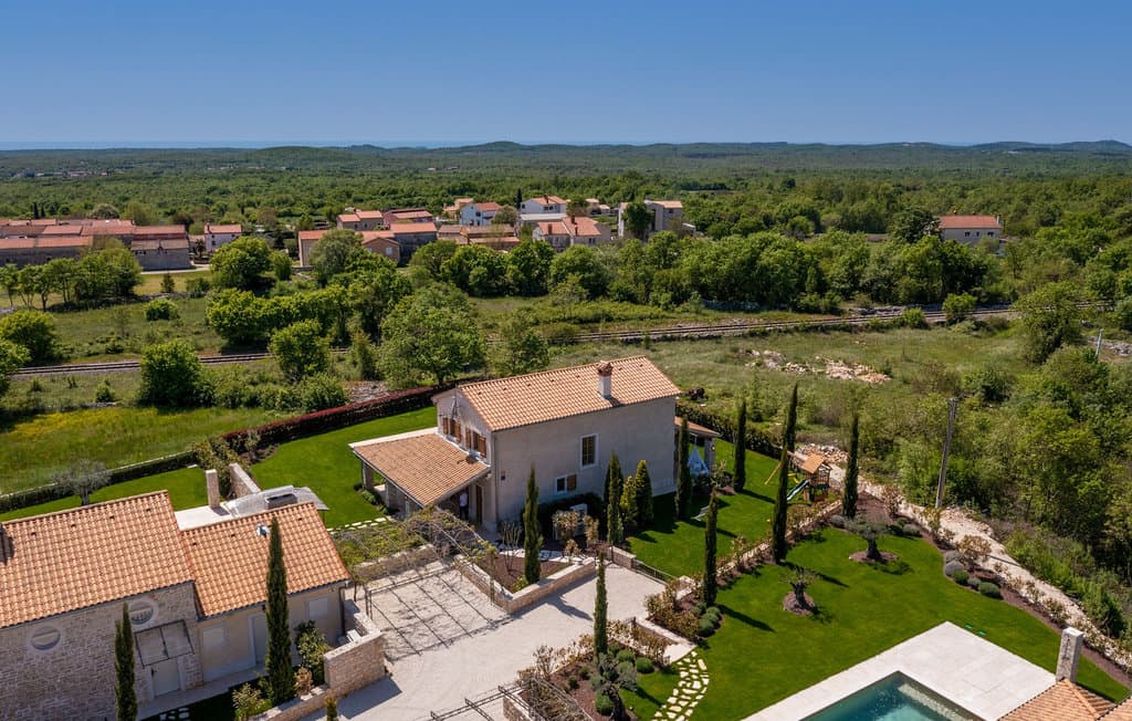 Sunset view over the illuminated pool and terrace of Villa Andrea