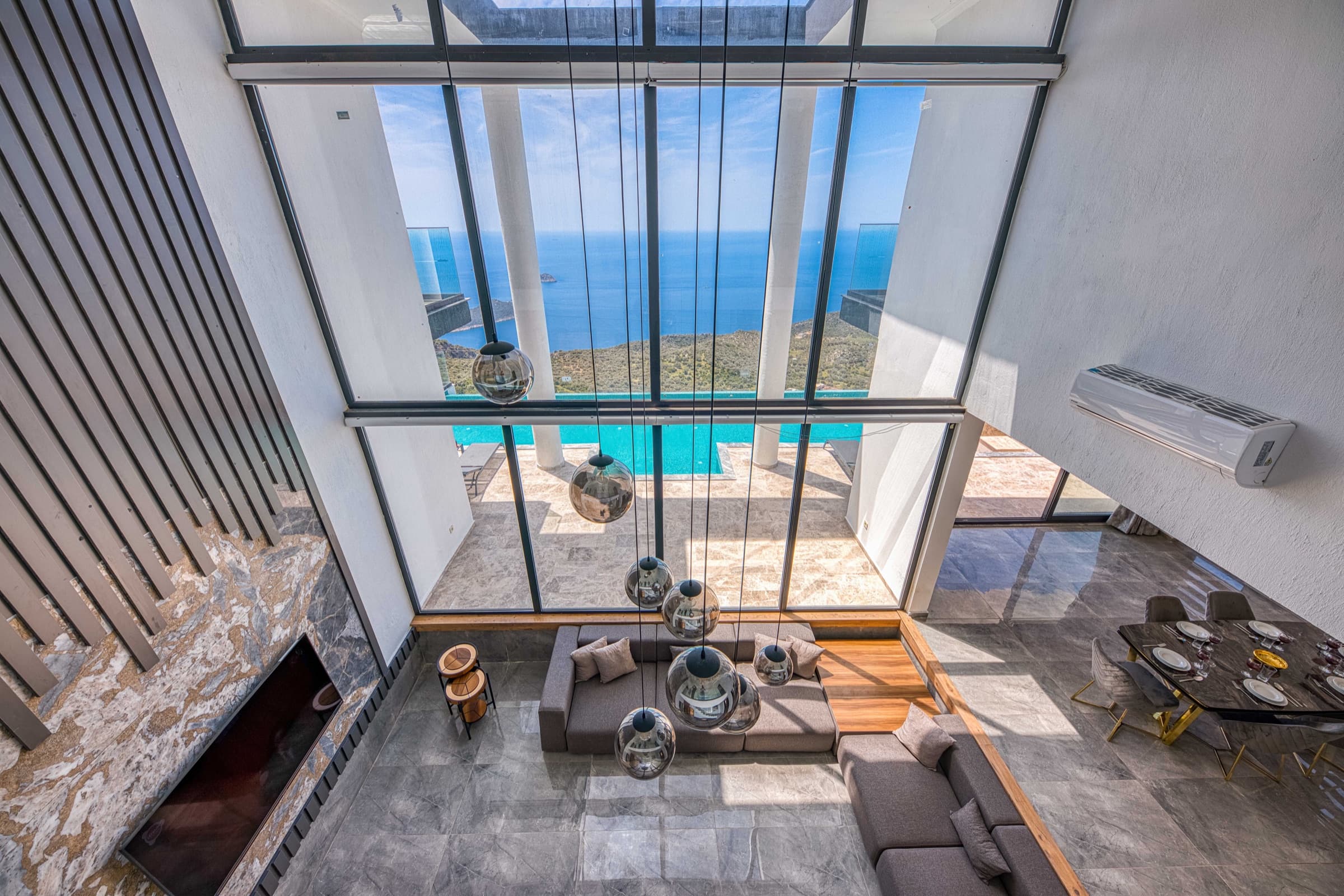 Double-height villa interior with panoramic sea views