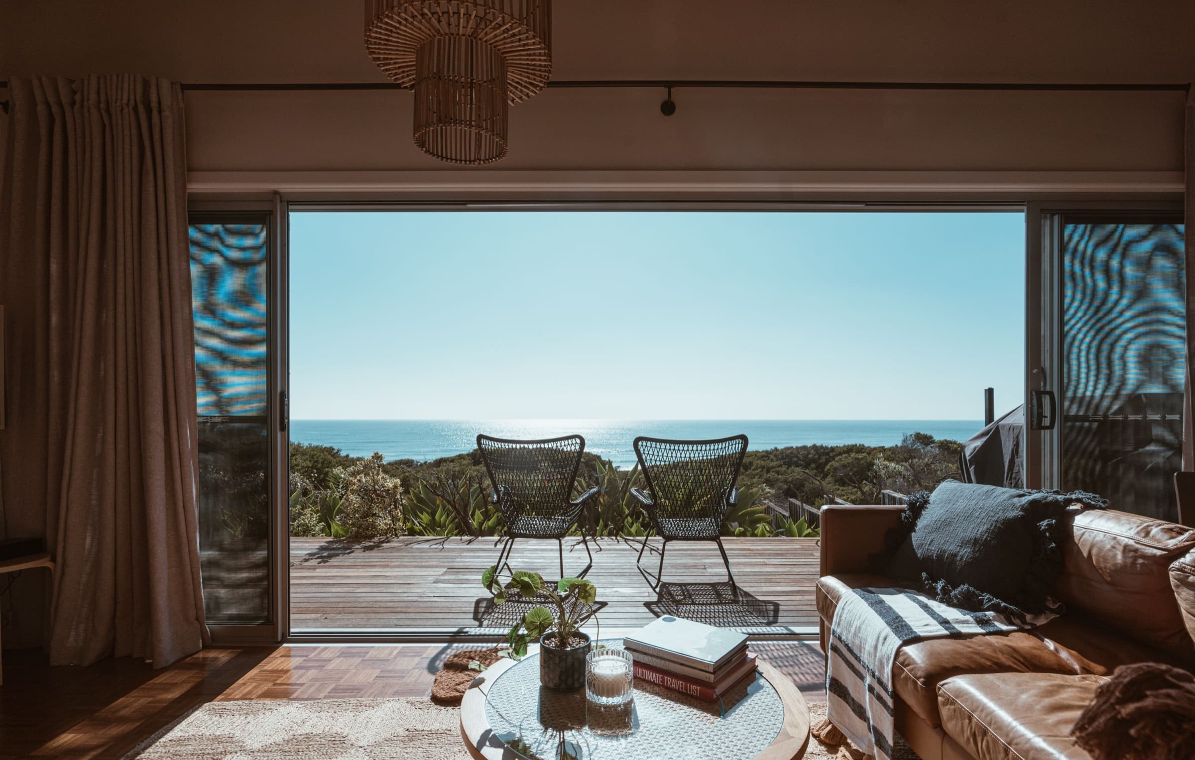 A warm living room opening onto a private terrace and the Adriatic